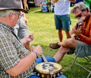 Greg Deering getting a chance to catch up with old friend Harvey Reid at Guthrie while working on a banjo