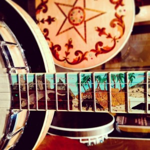 A section of the one and only Banjosaurus Long Neck! Owner George Grove of the Kingston Trio has loaned it to the museum to be on display there for one year. Now is the time to see it! The dinosaur scene of the neck is made up of intricately hand cut inlays of several different kinds of stone.