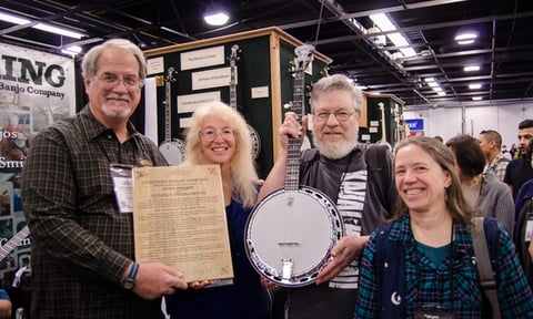 Greg and Janet Deering presenting Deering's 100,000th banjo made to Stan Werbin and Cynthia Bridge